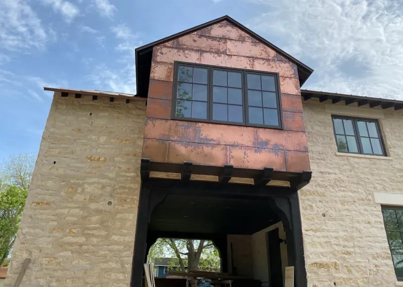 Copper metal panel facade on a stone building for Roof Repair in Arden Hills
